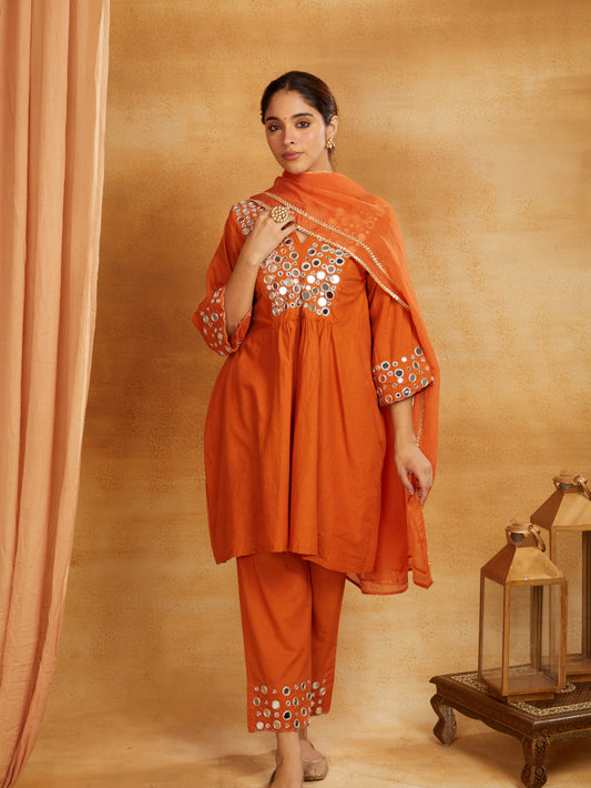 Rust orange kurta, pant, and dupatta with mirror work