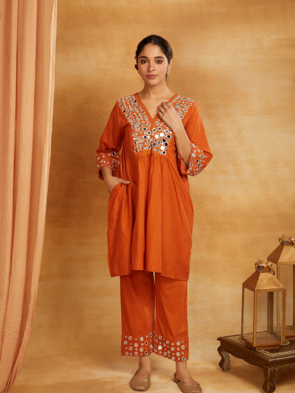 Rust orange kurta, pant, and dupatta with mirror work