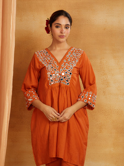 Rust orange kurta, pant, and dupatta with mirror work