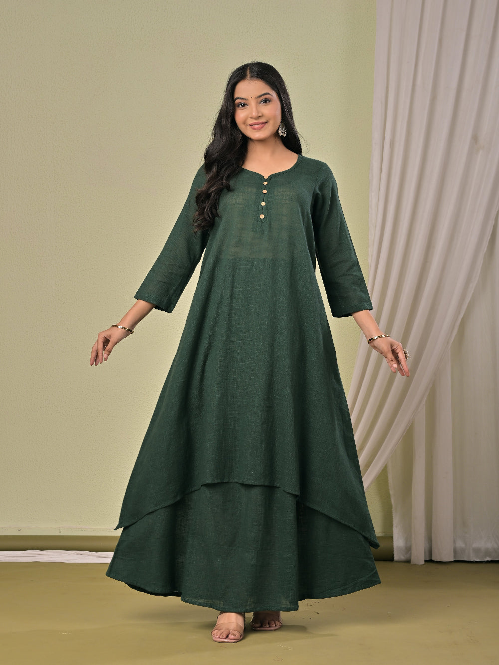 Bottle Green pure cotton double-layer dress. It comes with a long skirt below the ankle and an asymmetric overlay dress on top. It has two pockets