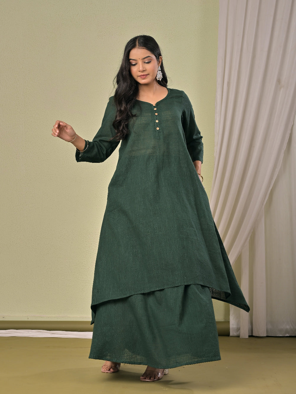 Bottle Green pure cotton double-layer dress. It comes with a long skirt below the ankle and an asymmetric overlay dress on top. It has two pockets