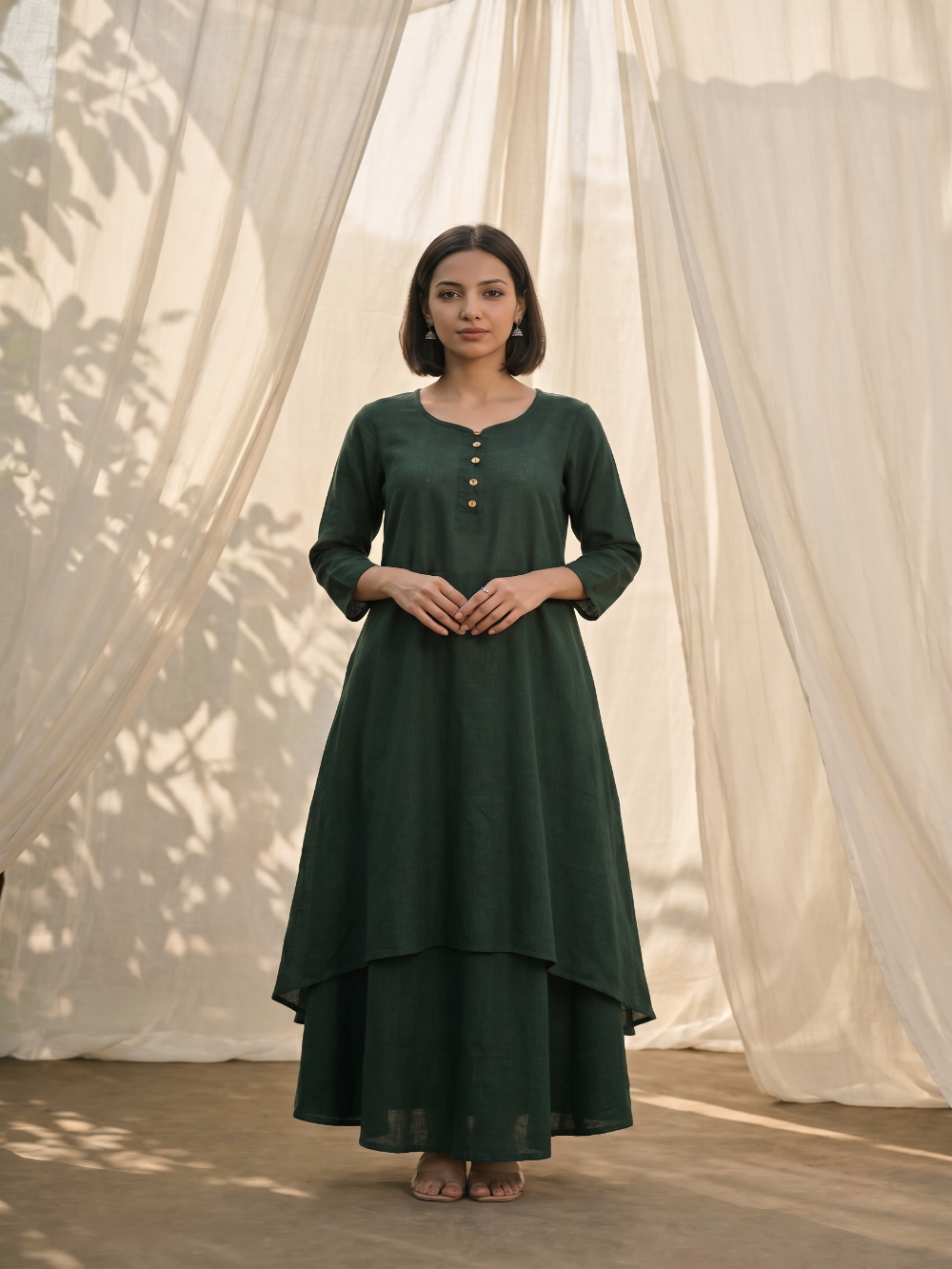 Bottle Green pure cotton double-layer dress. It comes with a long skirt below the ankle and an asymmetric overlay dress on top. It has two pockets